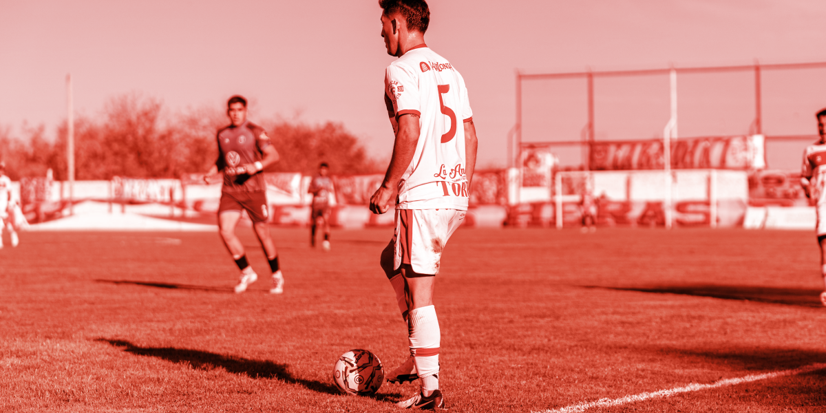 Football player ready to kick the ball. With a red branded overlay 