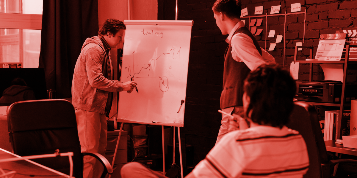 Start up business with 3 people making a business plan. Red colour brand overlay 