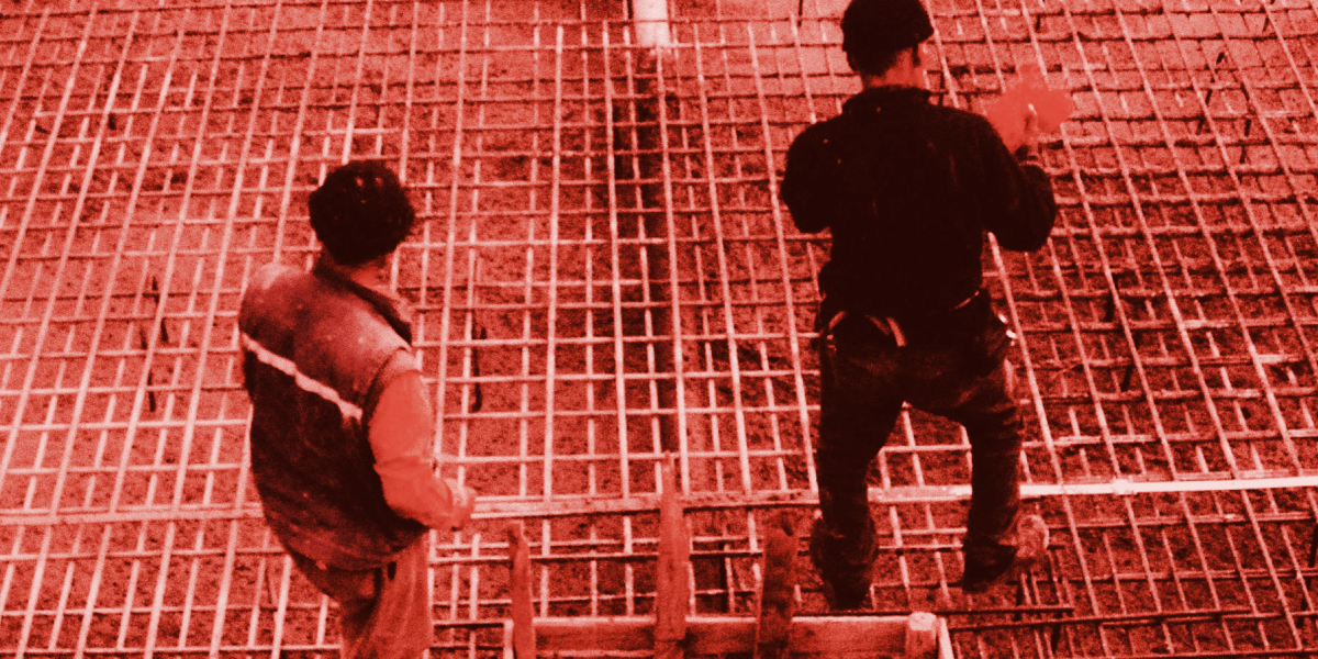 Construction workers laying foundations